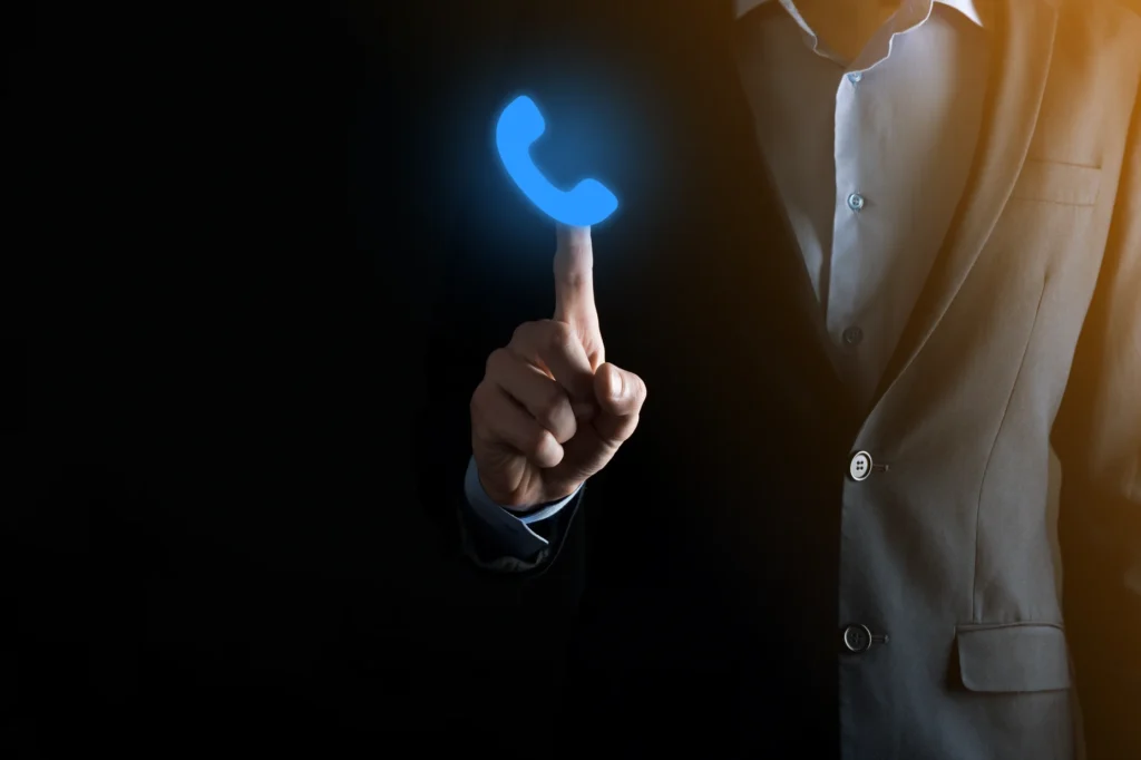 Ouvidoria-empresario-de-terno-em-fundo-preto-segura-icone-de-telefone